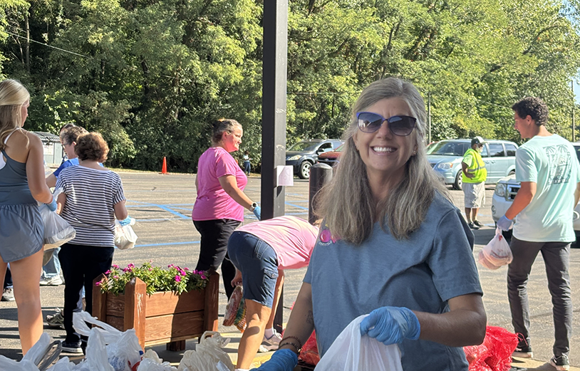Woman with sunglasses participating in trash pickup