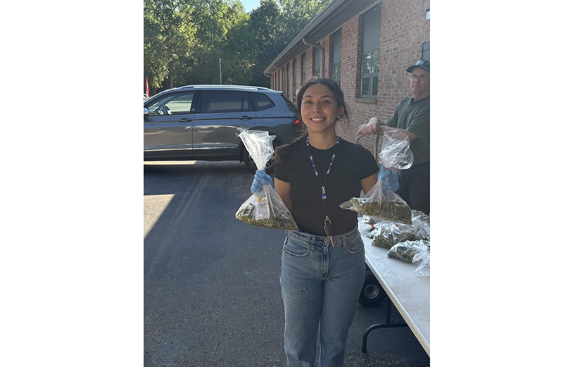Woman in parking lot holding bag