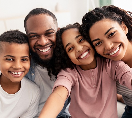 Family smiling after a visit to their Delta Dental Premier dentist in Stevensville