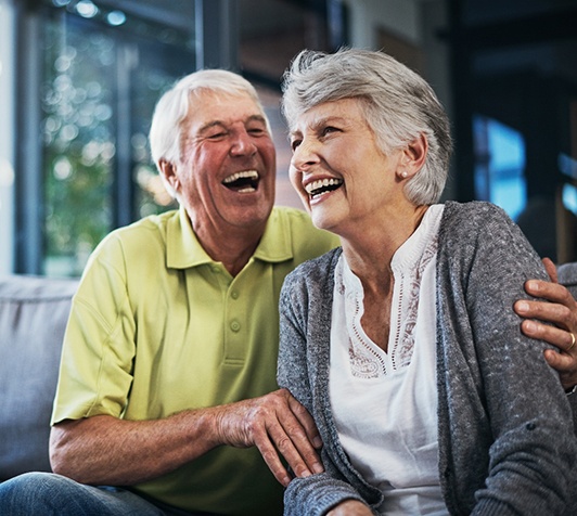Older couple smiling and hugging