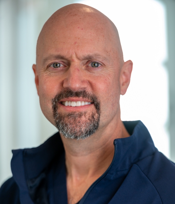 Female dental team member with glasses smiling