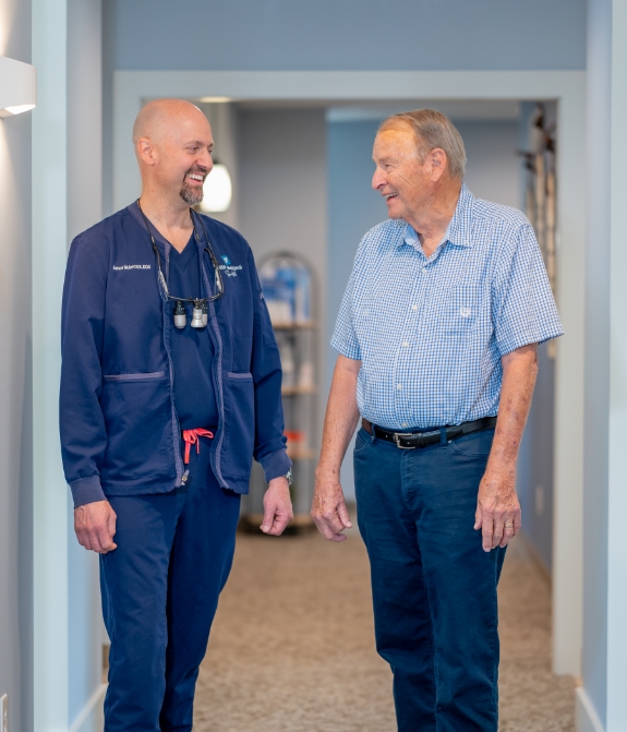 Dentist showing patient model of teeth